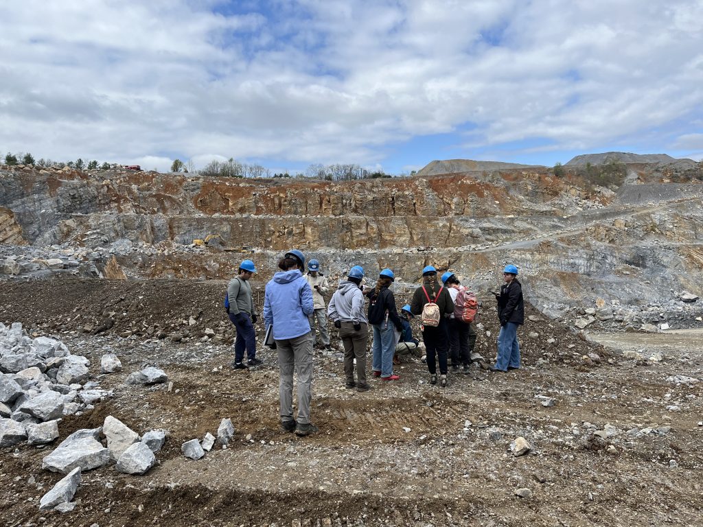 Fundamentals of Geology students examining calcite veins within limestone.